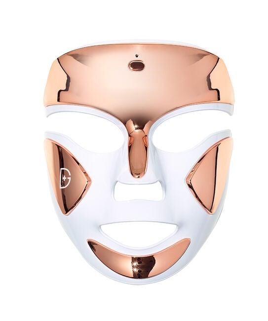 A close-up of the Dr. Dennis Gross DRx SpectraLite FaceWare Pro LED Mask being worn by a person, showing the mask's design and the glow of the LED lights on their face, indicating active use.