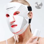 Person's face being treated with a red light and near infrared panel for skin rejuvenation and anti-aging.