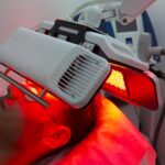 Red light therapy session targeting acne and skin inflammation, showing a gentle, soothing glow on the face